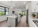 Bright, open kitchen featuring an island with seating, stainless steel appliances, and modern pendant lighting at 6248 Fish Eagle Ct, Nokomis, FL 34275