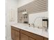 Clean laundry room with a stainless steel sink, a long countertop, and lots of cabinets at 6248 Fish Eagle Ct, Nokomis, FL 34275