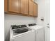 Spacious laundry room equipped with a washer, dryer, and extra storage cabinets at 6248 Fish Eagle Ct, Nokomis, FL 34275