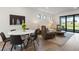 Bright living room boasts hardwood floors, a decorative rug, and large sliding glass doors to let natural light shine in at 6248 Fish Eagle Ct, Nokomis, FL 34275