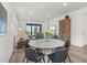 Bright living room boasts modern decor, hardwood floors, and large sliding glass doors to let natural light shine in at 6248 Fish Eagle Ct, Nokomis, FL 34275