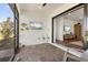 Enclosed outdoor patio with comfortable seating and a view to the interior with TV and decorative fish and birds at 6248 Fish Eagle Ct, Nokomis, FL 34275
