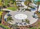 Outdoor pool seating area including lounge chairs, tables with umbrellas, and tropical landscaping at 6248 Fish Eagle Ct, Nokomis, FL 34275