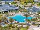 Aerial view of the community pool and lounge area surrounded by palm trees, umbrellas and beautiful landscaping at 6248 Fish Eagle Ct, Nokomis, FL 34275