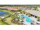 Aerial shot of the community pool area with a pool house, landscaping and houses in the background at 6290 Mesa Gln, Bradenton, FL 34203