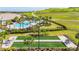 Beautiful aerial view featuring a pool, clubhouse and an outdoor bocce court at 6290 Mesa Gln, Bradenton, FL 34203