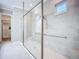 Walk-in shower with glass door, grab bars, and a bench in neutral colors and small window at 6290 Mesa Gln, Bradenton, FL 34203