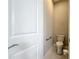 Powder room features a toilet, safety bar, and neutral paint and tile. Includes a door at 6290 Mesa Gln, Bradenton, FL 34203