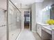 Modern bathroom showcases a sleek glass shower, white vanity, and neutral tile flooring at 6290 Mesa Gln, Bradenton, FL 34203