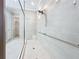 Walk-in shower features a glass door, handrails, and a shower head, all in neutral tones at 6290 Mesa Gln, Bradenton, FL 34203