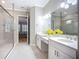 Elegant bathroom with dual sinks, quartz counters, glass shower, and access to the main bedroom at 6290 Mesa Gln, Bradenton, FL 34203