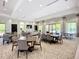 Bright clubhouse featuring tables, chairs, a ping pong table, and access to a pool with beautiful views at 6290 Mesa Gln, Bradenton, FL 34203
