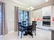 Dining area with black table and chairs, sliding glass doors and access to the kitchen at 6290 Mesa Gln, Bradenton, FL 34203