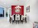 Dining room showcases a modern table set, chandelier, and a view through to the foyer at 6290 Mesa Gln, Bradenton, FL 34203