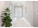 Bright foyer features white tile flooring, tray ceiling, and a decorative mirror at 6290 Mesa Gln, Bradenton, FL 34203