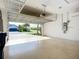 Spacious garage with epoxy flooring, overhead storage, and an automatic garage door at 6290 Mesa Gln, Bradenton, FL 34203