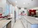 Modern kitchen features white cabinets, a large island, and stainless steel appliances at 6290 Mesa Gln, Bradenton, FL 34203
