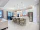 Bright kitchen with white cabinets, a large island with seating, and stainless steel appliances at 6290 Mesa Gln, Bradenton, FL 34203