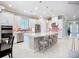 Modern kitchen features white cabinets, stainless steel appliances, and a large island with seating at 6290 Mesa Gln, Bradenton, FL 34203