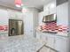 Kitchen features white cabinets, stainless steel appliances, and a red and white backsplash at 6290 Mesa Gln, Bradenton, FL 34203