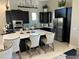 Modern kitchen with stainless steel appliances, a center island with barstool seating, and sleek cabinetry at 6290 Mesa Gln, Bradenton, FL 34203