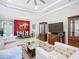 Spacious living room with a dining area, a large TV, and elegant furnishings at 6290 Mesa Gln, Bradenton, FL 34203