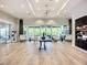Lobby of the community clubhouse featuring wood floors, ample seating, and views of the outdoor amenities at 6290 Mesa Gln, Bradenton, FL 34203