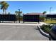 Community mailboxes with lush landscaping, palm trees, and a peek of the tennis courts at 6290 Mesa Gln, Bradenton, FL 34203