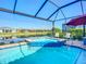 Screened in pool has attached spa and views of the lake and surrounding community at 6290 Mesa Gln, Bradenton, FL 34203