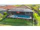 Screened pool with an attached spa and comfortable lounge chairs, perfect for outdoor relaxation at 6290 Mesa Gln, Bradenton, FL 34203