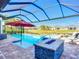 Screened in pool has attached spa, sun umbrella, a fire pit, and gorgeous views of the green space at 6290 Mesa Gln, Bradenton, FL 34203