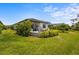 Beautiful backyard patio with stone accents and lush landscaping offers a relaxing outdoor space at 6295 Crested Eagle Ln, Nokomis, FL 34275