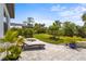 Peaceful backyard with patio, lounge chairs, lush landscaping, and space for outdoor relaxation at 6295 Crested Eagle Ln, Nokomis, FL 34275