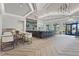 The clubhouse's bar area features a large counter, ample seating, and stylish light fixtures at 6295 Crested Eagle Ln, Nokomis, FL 34275