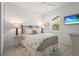 Cozy bedroom featuring a comfortable bed, a TV, and bright, natural light from the windows at 6295 Crested Eagle Ln, Nokomis, FL 34275