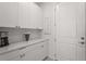 Well-organized butler's pantry with elegant cabinetry, a white counter, and a convenient coffee station at 6295 Crested Eagle Ln, Nokomis, FL 34275