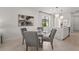 Dining area next to the kitchen features a table with seating for four and backyard views at 6295 Crested Eagle Ln, Nokomis, FL 34275