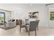 Dining area next to the living room features a table with seating for four and modern decor at 6295 Crested Eagle Ln, Nokomis, FL 34275