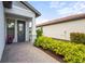 Inviting front entrance with manicured landscaping at 6295 Crested Eagle Ln, Nokomis, FL 34275