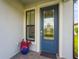 Stylish front door with decorative glass and sidelight window at 6295 Crested Eagle Ln, Nokomis, FL 34275