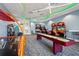 Arcade and game room featuring air hockey, driving games, shuffleboard and carpet at 6295 Crested Eagle Ln, Nokomis, FL 34275