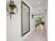 Elegant hallway with a large mirror and views into the open-concept living spaces at 6295 Crested Eagle Ln, Nokomis, FL 34275