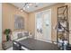 Comfortable office space featuring modern decor, a glass desk, and access to an adjoining room at 6295 Crested Eagle Ln, Nokomis, FL 34275