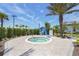 Inviting hot tub area with lush landscaping and a towel, perfect for relaxation at 6295 Crested Eagle Ln, Nokomis, FL 34275