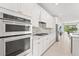 Bright kitchen showcases white cabinets, granite countertops, and stainless steel appliances at 6295 Crested Eagle Ln, Nokomis, FL 34275
