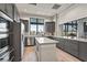 Modern kitchen with stainless steel appliances, a center island, and granite countertops at 6295 Crested Eagle Ln, Nokomis, FL 34275