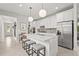 Modern kitchen features a center island with barstool seating and stainless steel appliances at 6295 Crested Eagle Ln, Nokomis, FL 34275