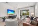 The stylish living room features a sofa, modern furniture, and sliding doors to an outdoor patio at 6295 Crested Eagle Ln, Nokomis, FL 34275