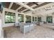 Inviting outdoor lounge area with comfortable seating, ceiling fans, and ample natural light at 6295 Crested Eagle Ln, Nokomis, FL 34275