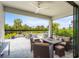 Inviting outdoor patio with a built-in grill, comfortable seating and lush tropical landscaping at 6295 Crested Eagle Ln, Nokomis, FL 34275